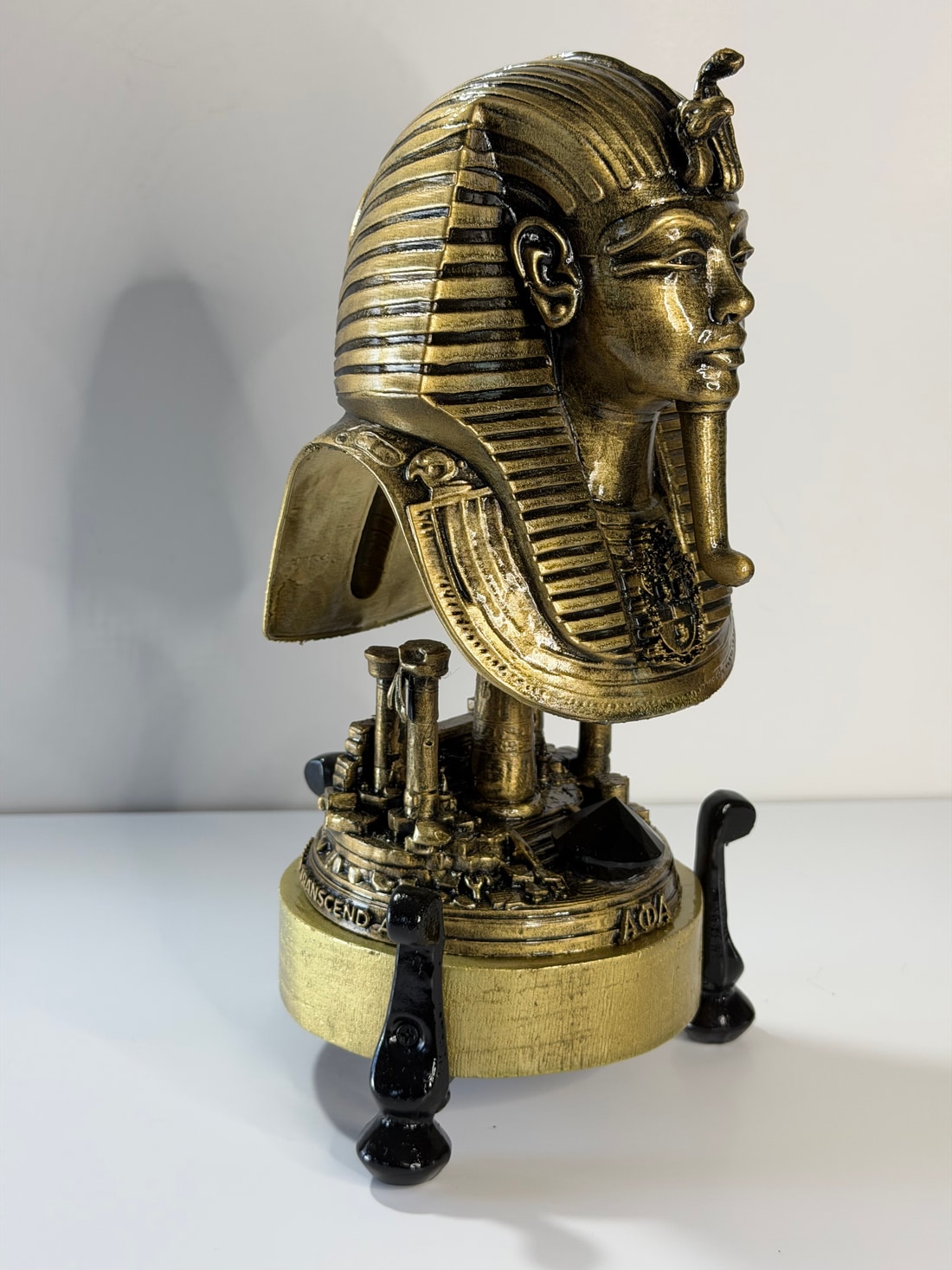 The silhouette: A sculptural profile, rising above a miniature temple.